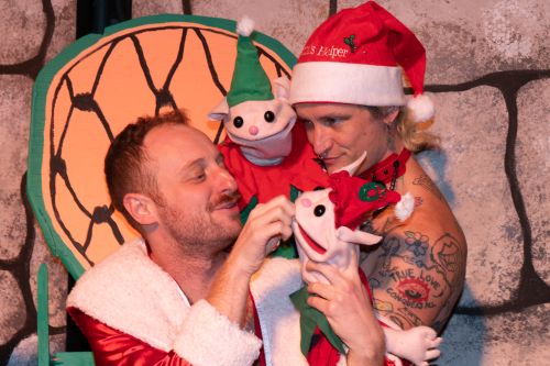 Sam Mayer as Santa canoodling two Elf puppets played by Dom Rabelais