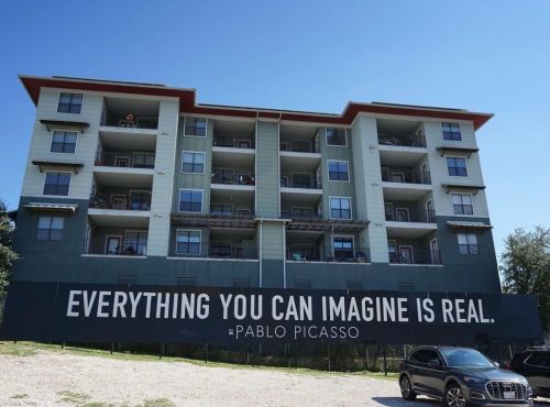 Housing development with large quote: "Everything you can imagine is real. -Pablo Picasso"