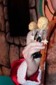 Closeup of dolls being held by Santa during a scene