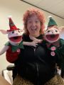 Emily Gilardi holding two elf puppets