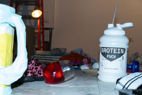 "fuck" flavored Brotein on the prop table